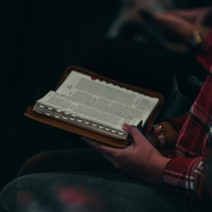 Close-up image of a person reading an open Bible. Captured in Jakarta, Indonesia.