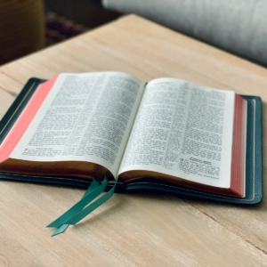 an open book sitting on top of a wooden table